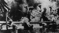 The speed of the Japanese advance into Malaya often depended on improvisation, which is shown here as soldiers hold up a makeshift bridge.