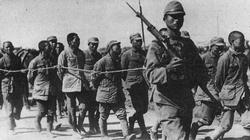 Chinese soldiers recently captured march away in to captivity.