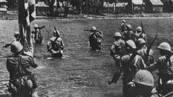Japanese troops wade ashore at Vigan, to the north of Lingayen Gulf, on the 10th December 1941.