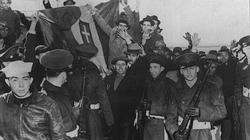 In March and April 1941 sixty five German and Italian ships that were in American ports were seized by the US authorities. Here Italian seaman, watched by US Soldiers, cheer and wave happily as their national flag is pulled down.