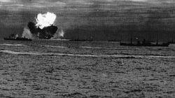 PQ-18 comes under attack. A British oiler explodes in flames as the rest of the group tries to keep formation.